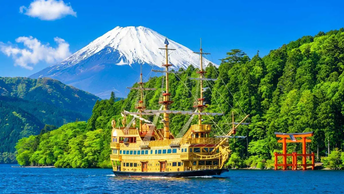 Red floating torii of Hakone Shrine seen from the water on a Lake Ashi cruise day tour from Tokyo, Hakone, Japan
